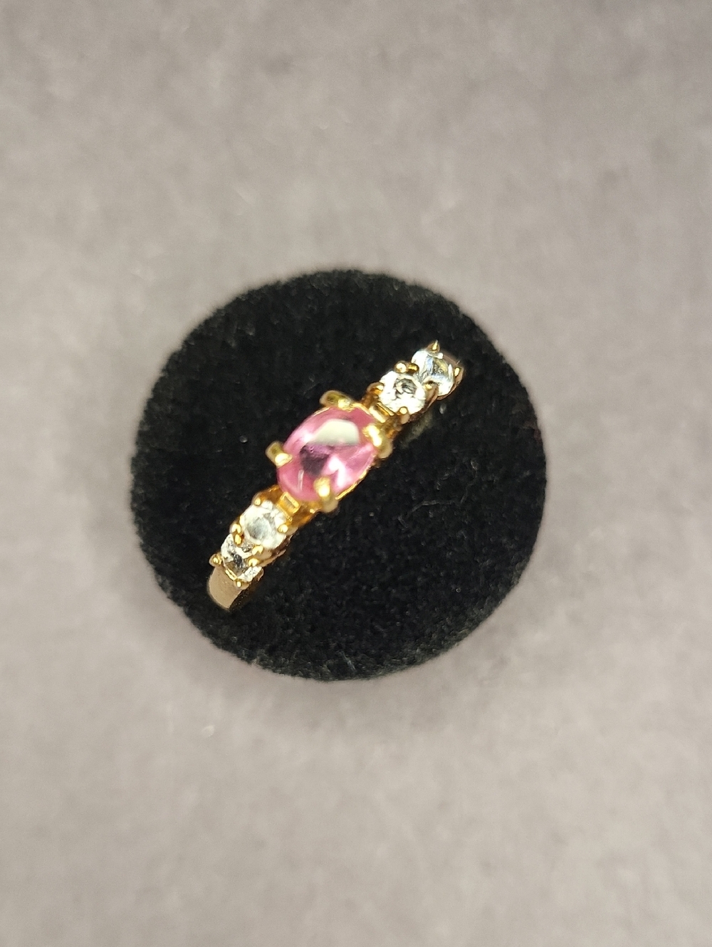 Gold Ring with Pink Center Stone and Clear Accent Stones